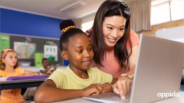 2 K12 student with teacher on laptop